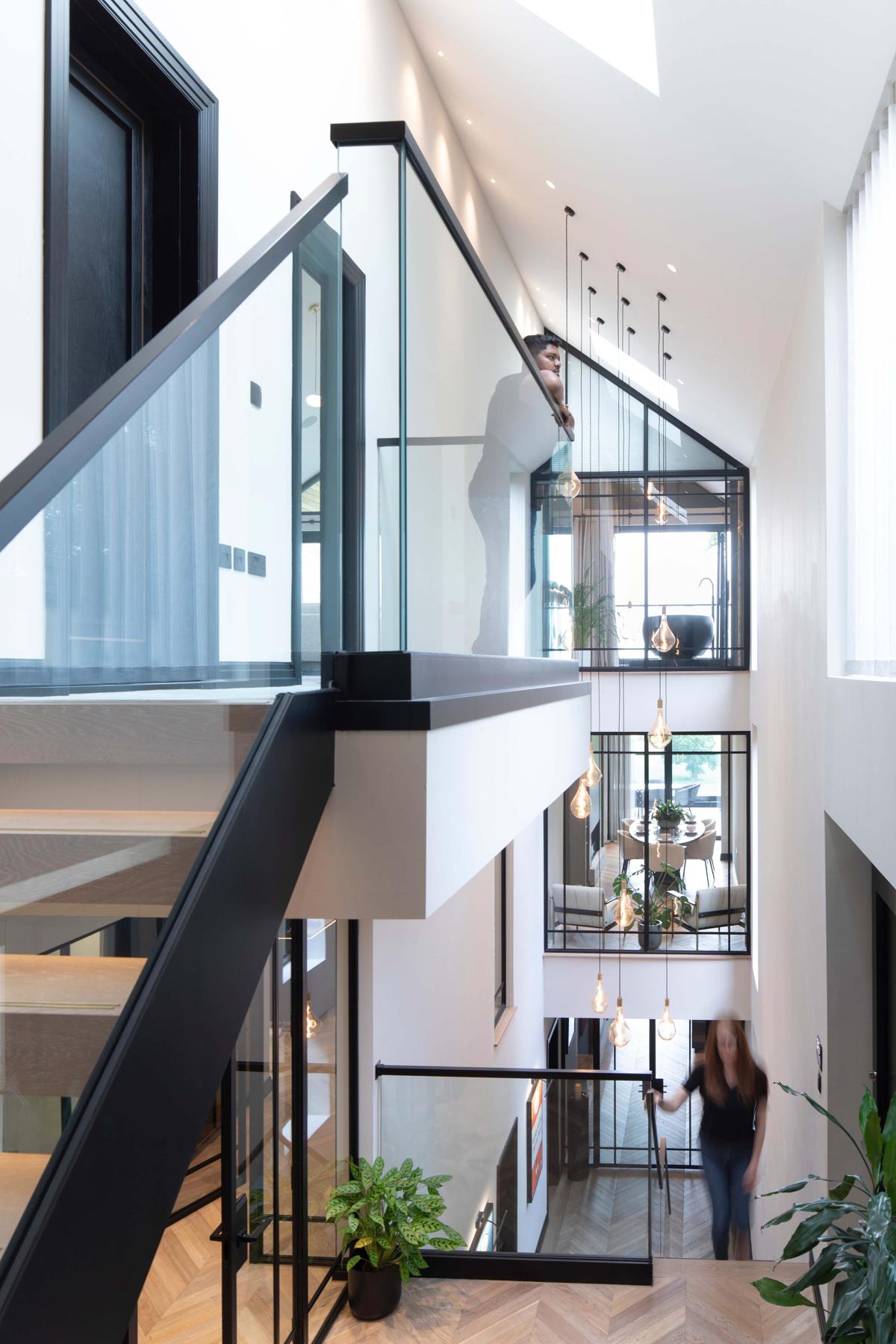 Steel glazing rising through a triple-height space